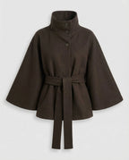 Dark brown belted cape jacket laid flat, showing the tie belt and flared bell sleeves in detail