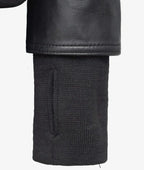 Close up of ribbed knit cuff against the smooth black leather sleeve