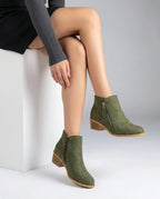 Olive green suede-effect ankle boots with side zip and block heel, shown from the side on crossed legs