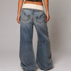 Rear view of the blue wide-leg jeans showing the ribbed waistband, back pockets and horizontal seam stitching