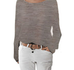 Close-up of taupe textured knit jumper showing the relaxed boat neckline and ribbed fabric detail