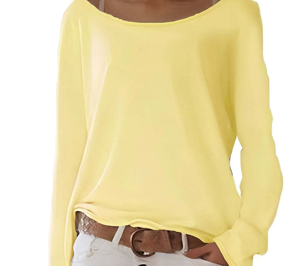 Close-up of pale yellow boat neck jumper showing the soft fabric texture and relaxed long sleeve fit