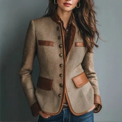 Close-up front view of a brown tweed blazer with tan leather trim, stand collar and button-front detailing worn over denim.