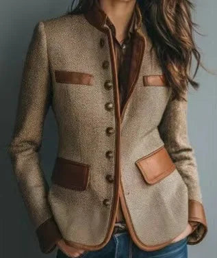 Side-angled view showing the tweed blazer's leather-trimmed chest and hip pockets, contrast piping and antique-style buttons.
