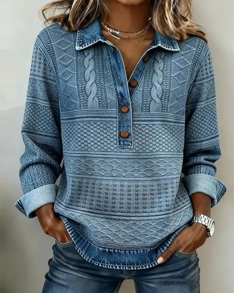 Close-up of blue denim cable knit jumper with shirt collar and wooden button placket, worn with jeans