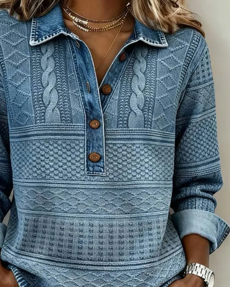 Front view of blue cable knit jumper showing collar, layered necklace and open button neckline