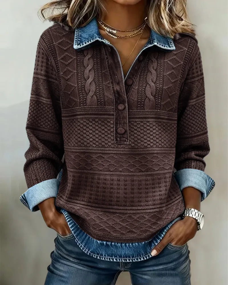 Brown cable knit jumper with blue denim collar and cuffs, hands in jean pockets