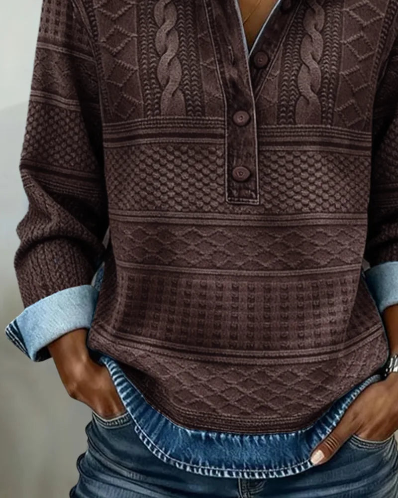 Close-up of brown knit texture showing cable, diamond and honeycomb stitch detailing with wooden buttons