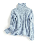 Light blue cable-knit polo neck jumper with textured leaf-pattern stitching, laid flat against a white background