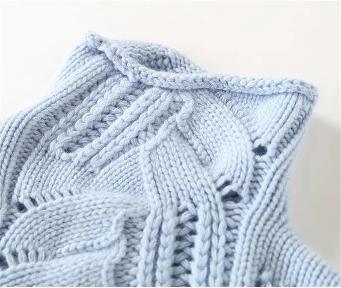 Close-up of the light blue polo neck collar showing ribbed trim and intricate cable and openwork stitching