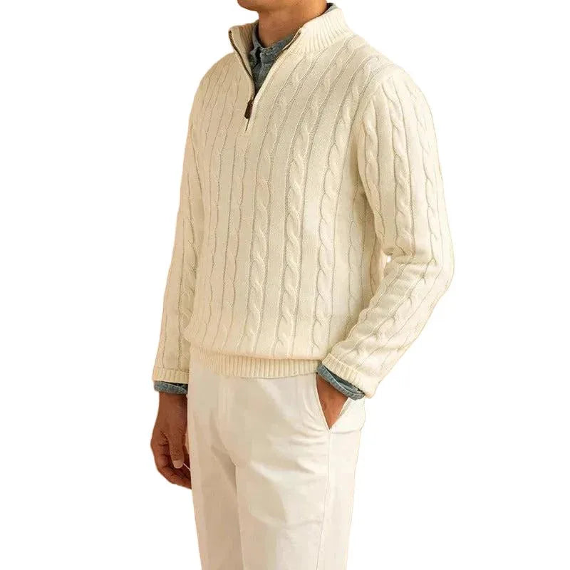 Side view of cream cable-knit quarter-zip jumper worn with white trousers and denim shirt underneath