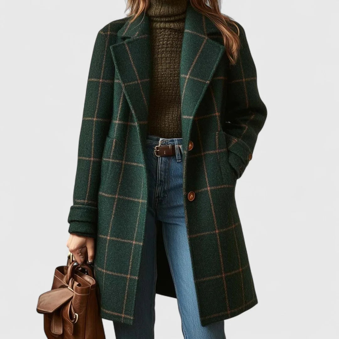 Woman wearing a green windowpane check wool coat open over a knit polo neck and jeans, front view