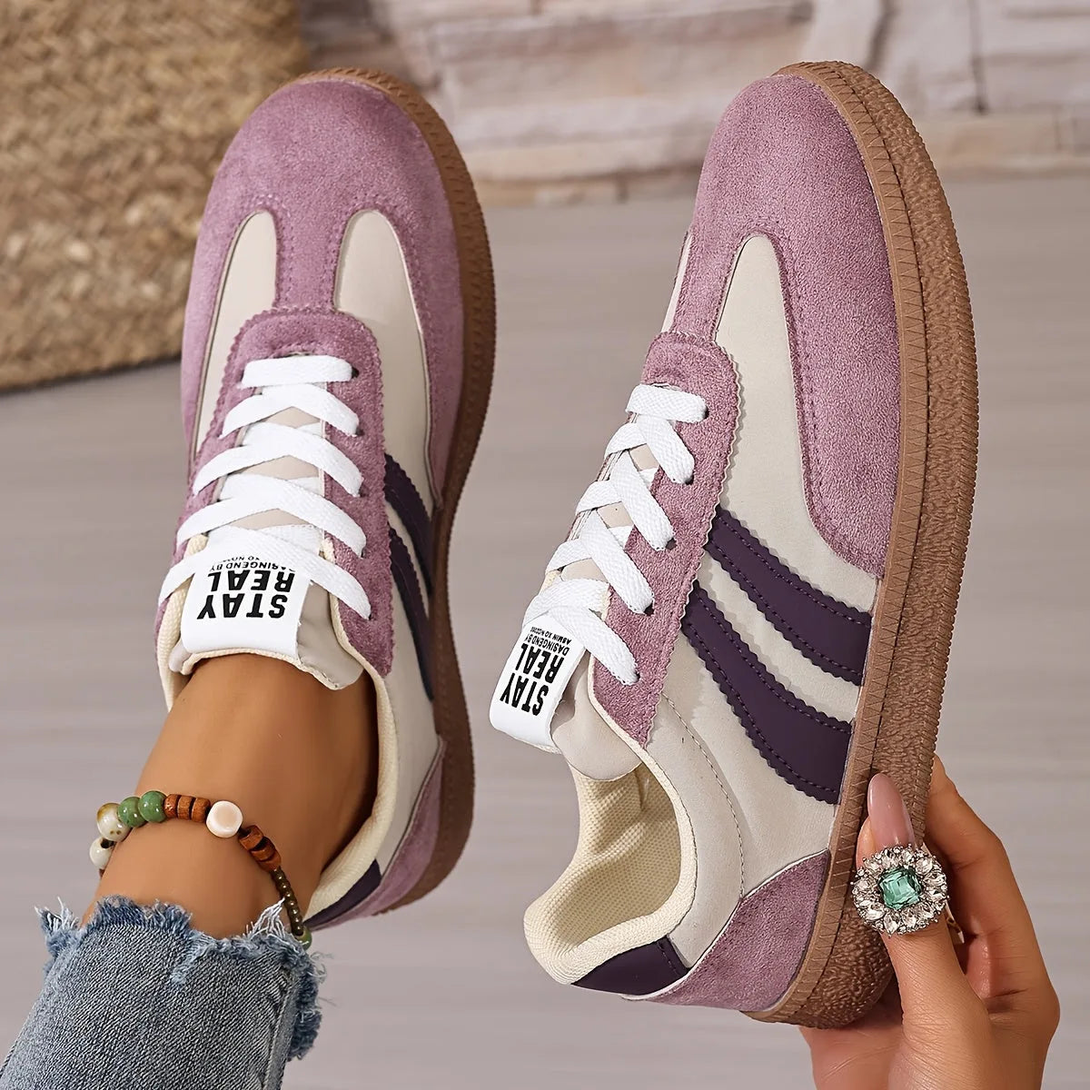 Top and side view of dusky pink and purple suede trainers with contrast stripes