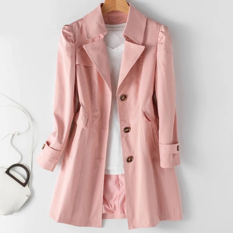 Pink belted-look trench coat with turned-back cuffs and welt pockets, shown open over a white top and matching shorts