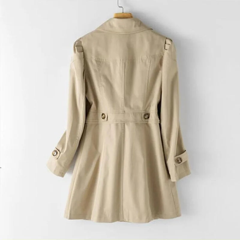 Back view of the khaki trench coat showing the fitted waist tab, button cuffs and flared, flowing hemline