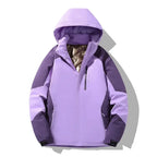 Front view of a lilac purple colourblock ski jacket with hood up, showing bronze-tone lining and chest zip pocket