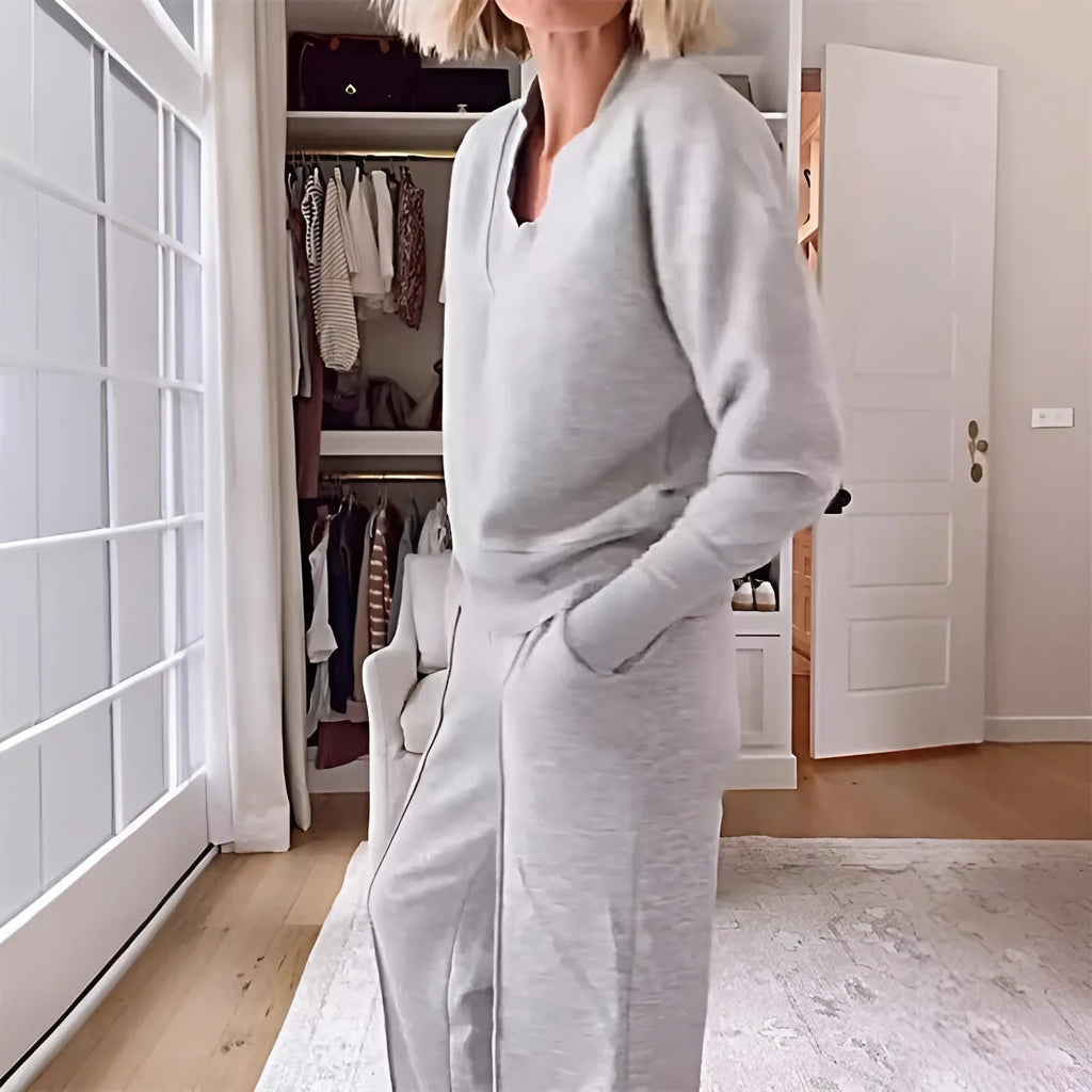 Side profile close-up of the grey v-neck jumper showing the ribbed collar and relaxed sleeve fit