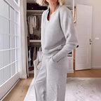 Side profile close-up of the grey v-neck jumper showing the ribbed collar and relaxed sleeve fit