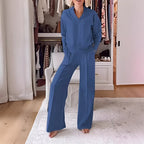 Front view of a woman wearing the set in denim blue, v-neck jumper and wide-leg trousers
