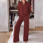 Front view of a woman wearing the set in a deep rust red tone with visible seam detailing on the trousers