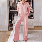 Front view of a woman wearing the set in soft pink, standing barefoot on a light rug