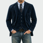 Front view of a navy corduroy blazer and waistcoat worn over a striped shirt and tie with jeans