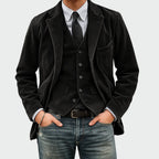 Front view of the same layered blazer and waistcoat in charcoal black corduroy over a striped shirt