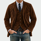 Front view of the tailored corduroy blazer and waistcoat set in rich brown, layered over a tie and shirt