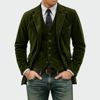 Front view of the corduroy blazer and matching waistcoat in deep olive green with denim trousers