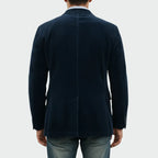 Back view of the navy corduroy blazer showing the centre seam and clean tailored fit