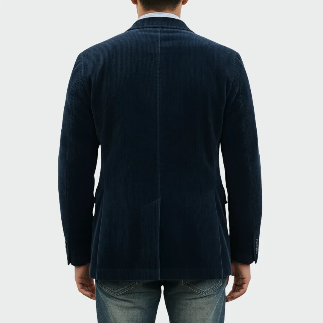 Back view of the navy corduroy blazer showing the centre seam and clean tailored fit
