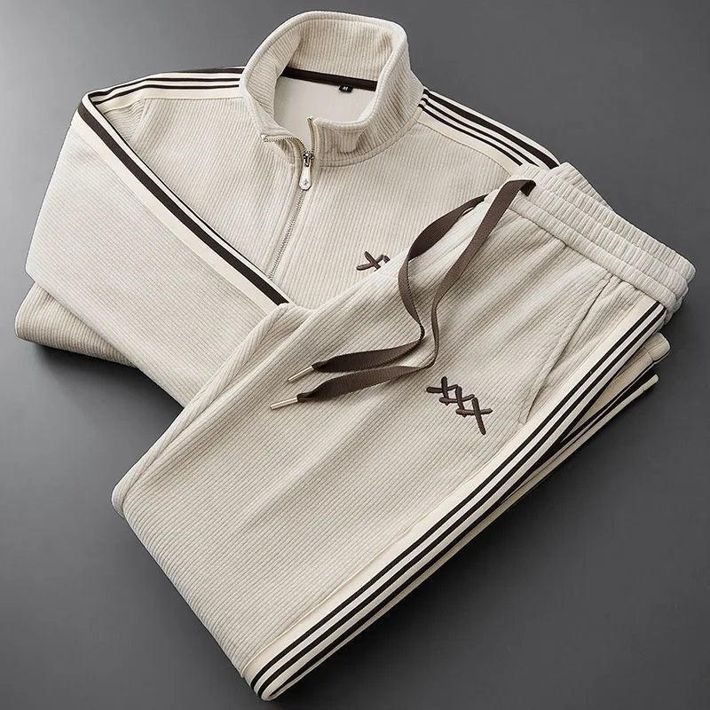 Cream corduroy tracksuit set folded flat, highlighting the ribbed knit texture and contrast brown stripe detailing