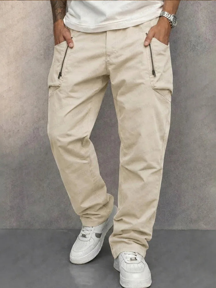 Cream cargo trousers styled with white trainers, showing tapered ankle and clean waistband