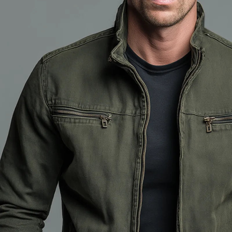 Close-up of the chest area showing stand collar, zip pockets and worn-in cotton texture of the jacket