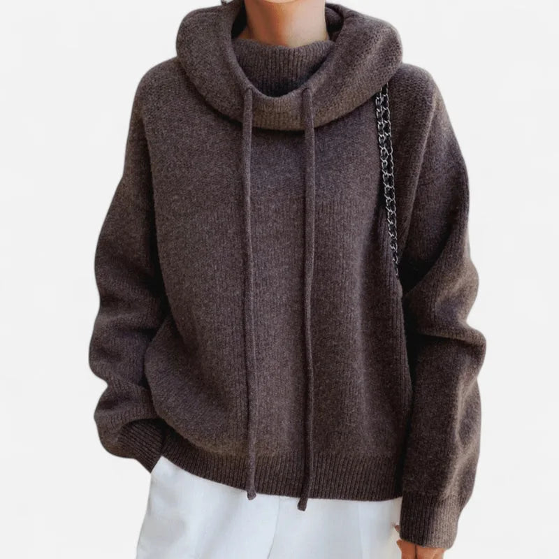 Front view of brown cowl neck hooded jumper showing oversized sleeves and ribbed hem