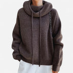 Front view of brown cowl neck hooded jumper showing oversized sleeves and ribbed hem