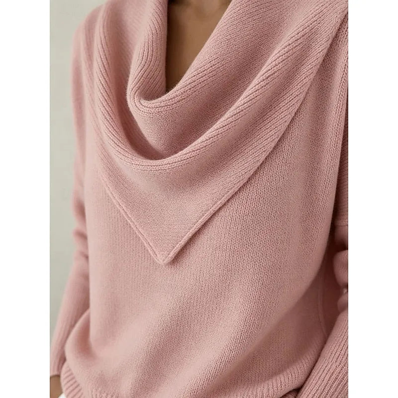 Close-up detail of the cowl neckline folds showing the ribbed knit trim and soft fabric texture