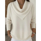 Front view of the jumper in cream white, showing the cowl neckline and relaxed knit fit