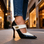Pointed-toe black and ivory colour-block stiletto shown from the front on a city pavement