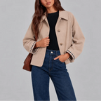 Close-up of a beige cropped trench jacket showing the wool-look texture and button front