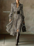 Close-up front shot showing the puff-sleeve bishop cuffs and button front of the diamond-print midi dress