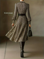 Back view of the dress showing the fitted waist, flared A-line skirt and collar in the brown and cream print