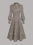 Flat lay of the full dress showing the collared V-neck, long bishop sleeves and swing skirt silhouette