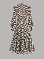 Flat lay back view of the midi dress highlighting the seamed waist and the flowing hemline
