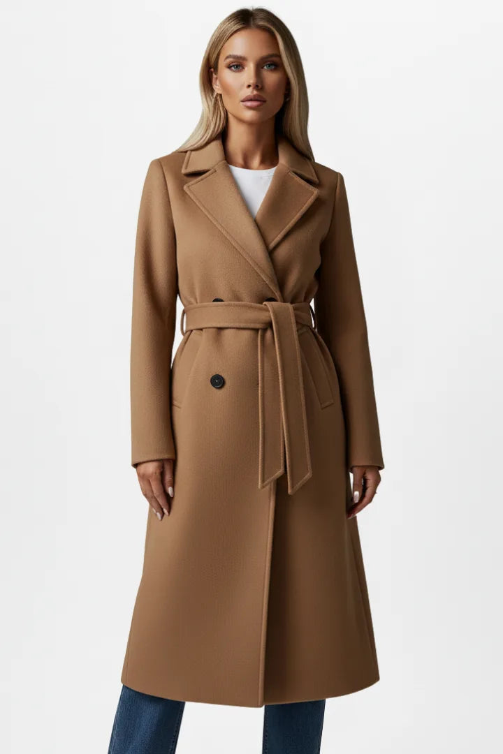 Close-up front view of a woman in a beige belted coat showing the tortoiseshell button fastening detail