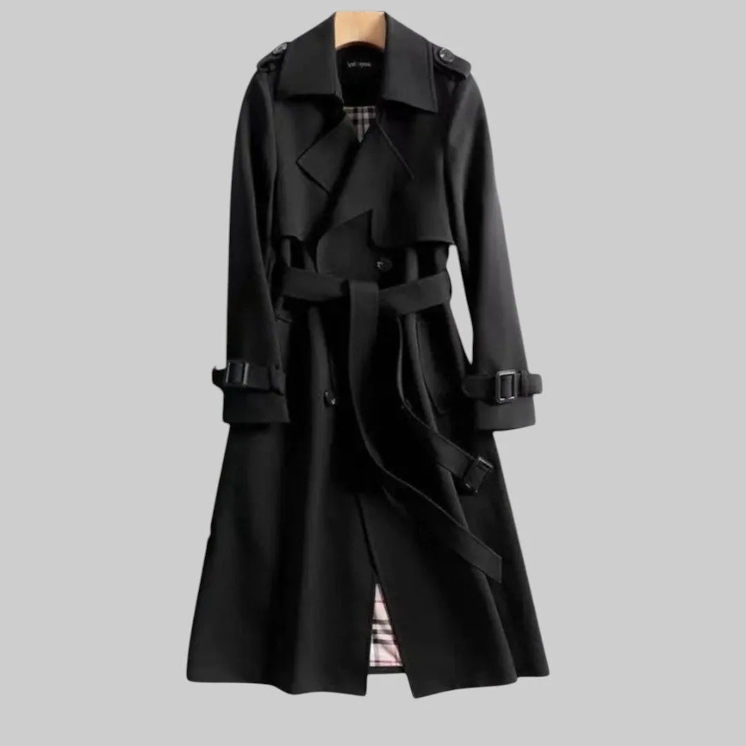 Black trench coat with notched lapel, wrap-style front and checked lining peeking through at the hem