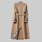 Back view of beige trench coat showing back belt strap, yoke seam and checked lining at the hem