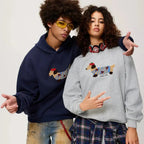 Two models wearing matching hoodies, one navy and one grey, both with the dachshund dog graphic