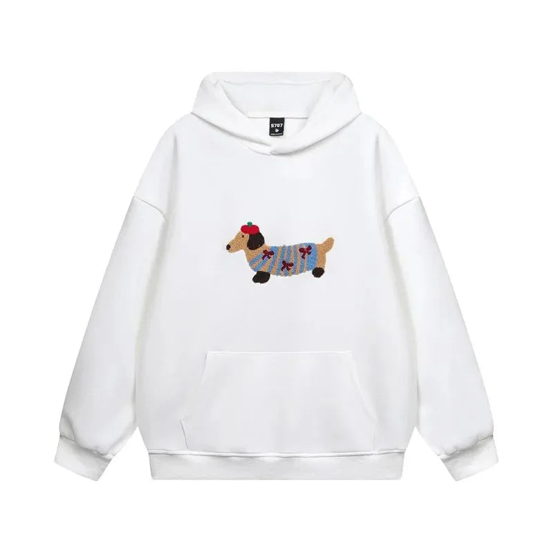 White hoodie laid flat showing the front pouch pocket and colourful dachshund dog embroidery