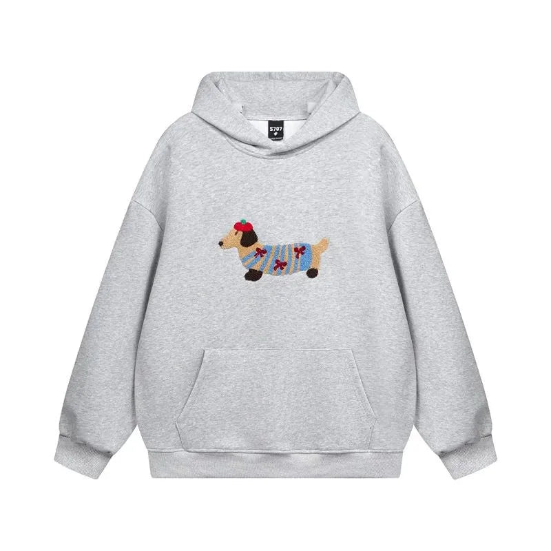 Grey hoodie laid flat, front view, showing ribbed cuffs, hood and the embroidered dog design